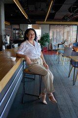 elderly woman in stylish summer business suit in modern office workspace