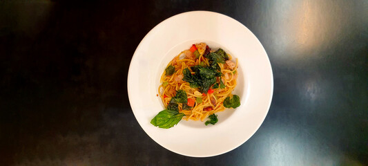 Spaghetti with Tomato Sauce and minced pork  in white plate on black background