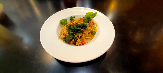 Spaghetti with Tomato Sauce and minced pork  in white plate on black background