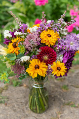 Obraz premium Summer bouquet. Beautiful multi colored fresh flower arrangement. Birthday bouquet made of summer flowers photographed outdoors.