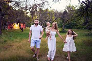 family of four on a walk in the park