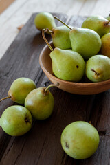 pears on a plate on a brown wooden table