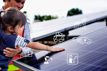 Solar cells have icons such as charging station, electric car, robot, inverter, energy saving industry. Above the solar panels, a girl's hand touches the solar farm.