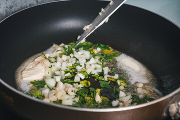 Preparation of the sauce for mussels: shallots, parsley and garlic are fried in butter.