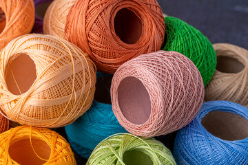 Multicolor yarn for knitting, knitting needles and scissors. Home storage concept and hobby.Raffia is an organic, ecological, wood fiber that is easy to crochet.