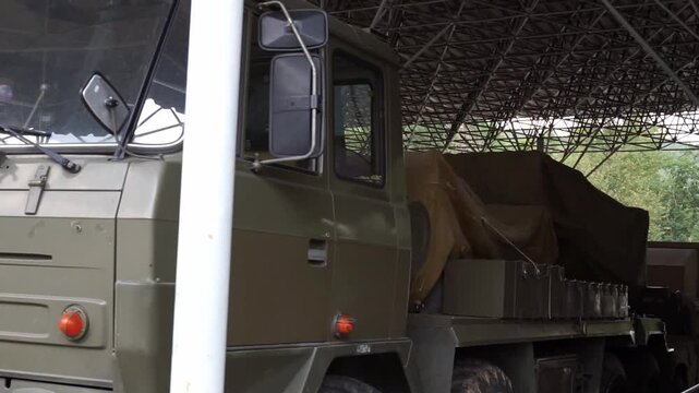 a military vehicle is standing in a hangar
