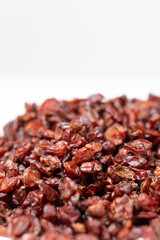 Red dried barberry on white background