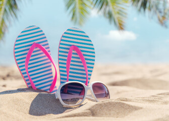 Flip flops and shades on the sea beach