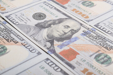 Background of US dollar bills. Selective focus. American vintage money cash, hundred dollar bills. Texture US dollars