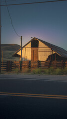 Rustic Barn in Sunset on Country Road