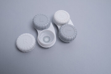 Container for lenses and accessories on a light background. Health and medicine concept
