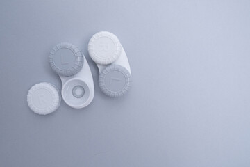 Container for lenses and accessories on a light background. Health and medicine concept
