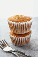 Banana cup cake with fork on light cement background 