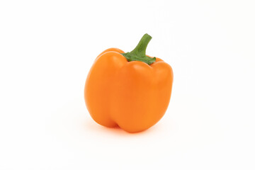 Orange sweet pepper with green stem on white background close-up