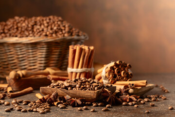 Coffee beans with spices on a brown vintage background.