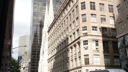 New York City Manhattan Midtown building architecture, urban street in United States. 5th Fifth 5 avenue residential and business property. St Patricks cathedral on rainy day. American Catholic church