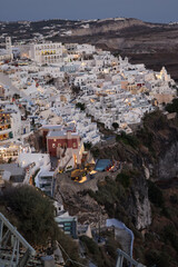  Illuminated balcony decks and patios with restaurants of Fira town on Santorini island. Cyclades,...