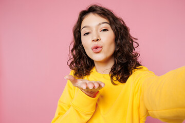 Close up young woman she wearing yellow sweatshirt casual clothes doing selfie shot pov on mobile...