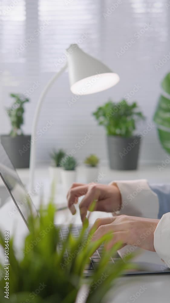 Poster a person is working in a bright and modern workspace, surrounded by greenery. the setup fosters a pr