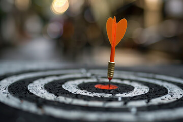 Fototapeta premium Arrow striking the bullseye on target during outdoor archery practice at sunset