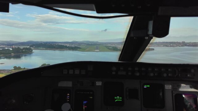 Real time approach to the runway 29 of Santander airport, Spain, shot from inside the cockpit. Captain piloting. 4K 60FPS