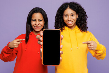 Two young little kid teen girls women they wear red yellow hoodie casual clothes hold use point...