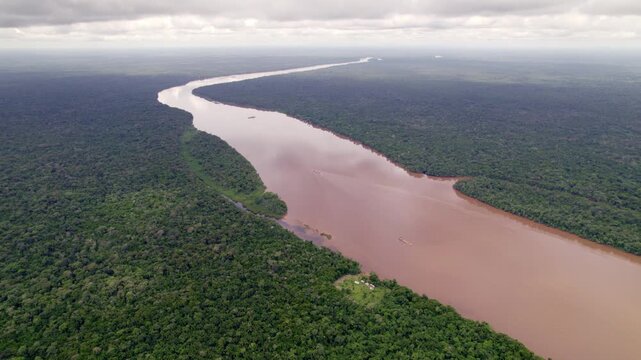 Aerial: Large fresh water river going through amazon rain forest, Suriname