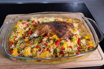 close-up of roast chicken over rice with vegetables