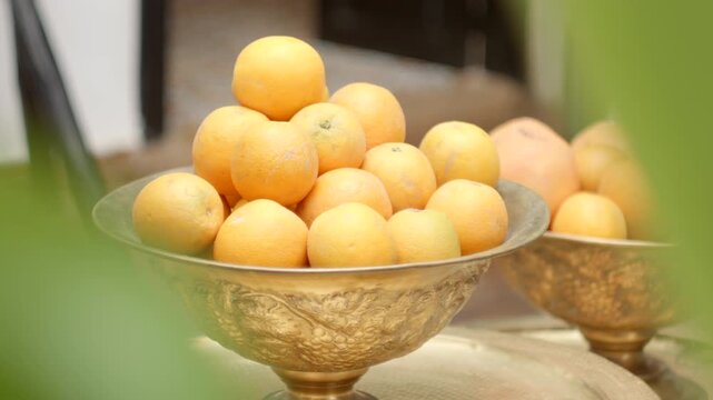 Bowl with Fresh Oranges on a Table in a House Blurred Elements Push In