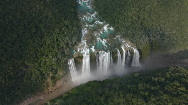 Panoramic aerial establishing overview of braided turquoise streams of water leading to Tamul Waterfall