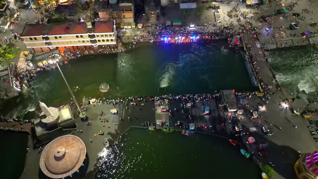 Aerial view of Nashik's Ramkund during the sandhya aarti at the banks of Godavari river a place of Hindu pilgrimage Maharashtra India 4K