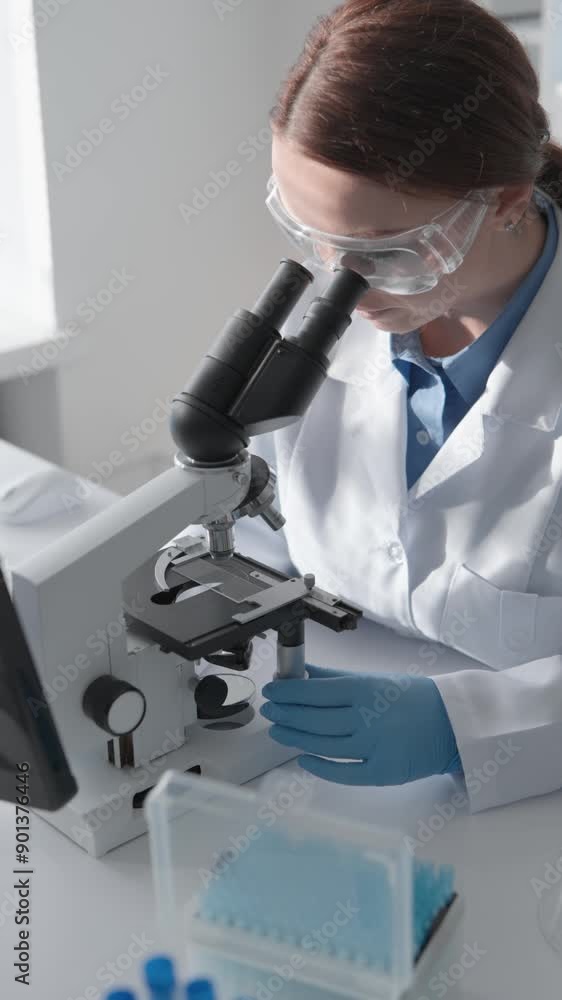Aufkleber In a laboratory, a scientist is employing advanced tools for precise microscopic analysis, contributing to biotechnology and healthcare research and fostering innovation in the field