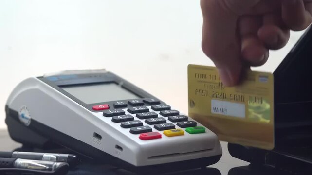 Ecommerce credit card swipe machine Online payment or banking transaction at clinic or store. Hand of customer tapping debit in transact for purchase, electronic pay or POS at optometry shop