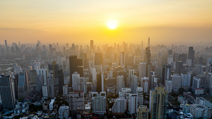 Aerial view Bangkok City skyline and skyscraper on Sathorn Road business and financial in Bangkok downtown. Bangkok cityscape in sunset time, Thailand. 