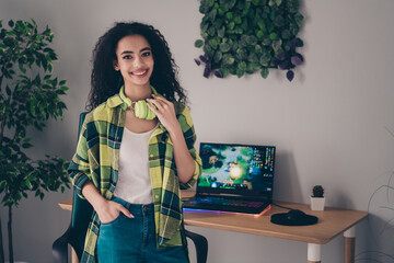 Photo of adorable sweet lady wear checkered shirt smiling playing computer games indoors room home house