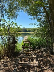 A small pier over a deep river. A fishing pier on a navigable river.
