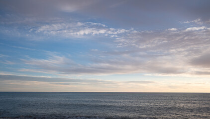 Blue sea and blue sky with white clouds. Seascape.