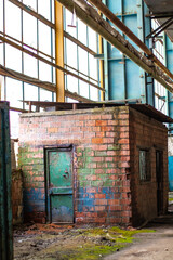 Old factory with objects abandoned inside and growing nature, power of life
