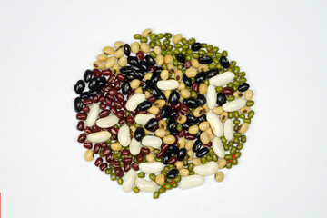 Heap of 5 colors mixed beans, black beans, azuki beans, green beans, white beans and soybean, isolated on white background top view. Diet and healthy food concept.