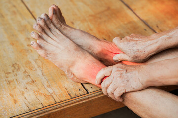 Close-up of a person experiencing foot pain, showcasing discomfort and tension in a natural setting.