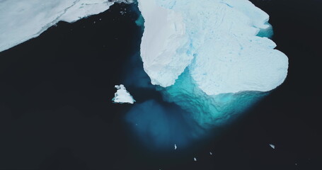 Huge ice glacier at polar nature environment. Blue water icebergs melting underwater in cold ocean...