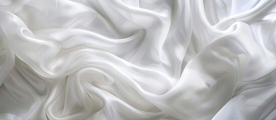 Obraz premium Soft waves and wrinkles on a white fabric create an abstract background with intricate patterns ideal for elegant backdrops or wallpapers with copy space image
