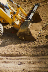 Close-up of a bulldozer bucket on a construction site vertical shot, bulldozer operation on a dirt...