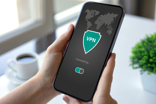 female hand holding phone with app vpn on the screen