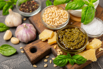 Pesto. Italian basil pesto sauce on a textured wooden background. Ingredient for pesto sauce: fresh...
