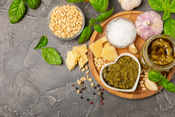 Pesto. Italian basil pesto sauce on a textured wooden background. Ingredient for pesto sauce: fresh...