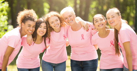 Breast Cancer Concept. Mutiracial Ladies In Pink T-Shirts With Ribbons Symbol Hugging Standing Outdoor