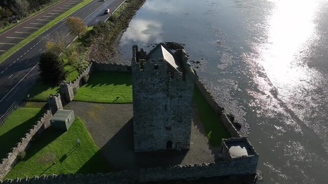 Narrow Water Castle, County Down, Northern Ireland, November 2022. Drone orbits the Tower House clockwise on the banks of the Newry river on a warm sunny winter morning.