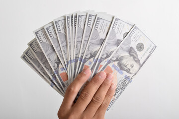 Man hand with dollars isolated on a white background. One hundred American money or 100 USD