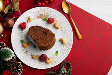Delicious piece of chocolate cake seen from an overhead perspective. Christmas decoration table.